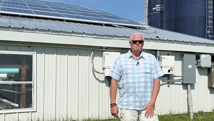 Edward Walldroff in front of his solar panels on farm in La Fargeville New York.