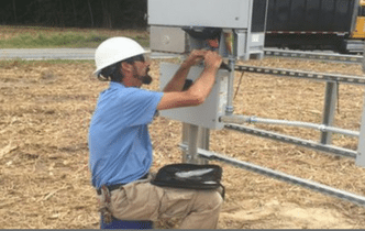 man doing maintenance work on solar panels