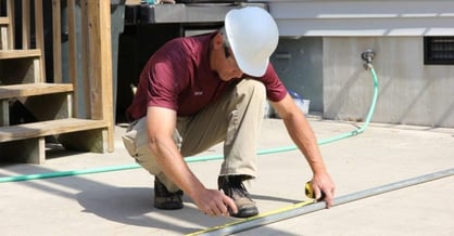 man measuring conduit