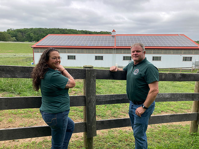 Gentle-Giant-Horse-Rescue-Owners-In-Front-of-Solar-Panels_2
